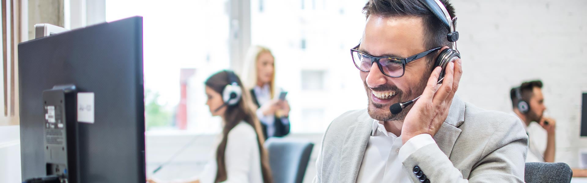 customer service representative smiling while on the phone